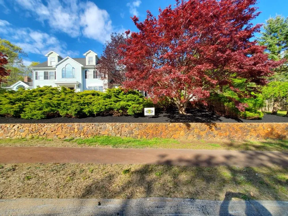 Custom landscape design for homes in Randolph, MA by Affordable Lawn Care