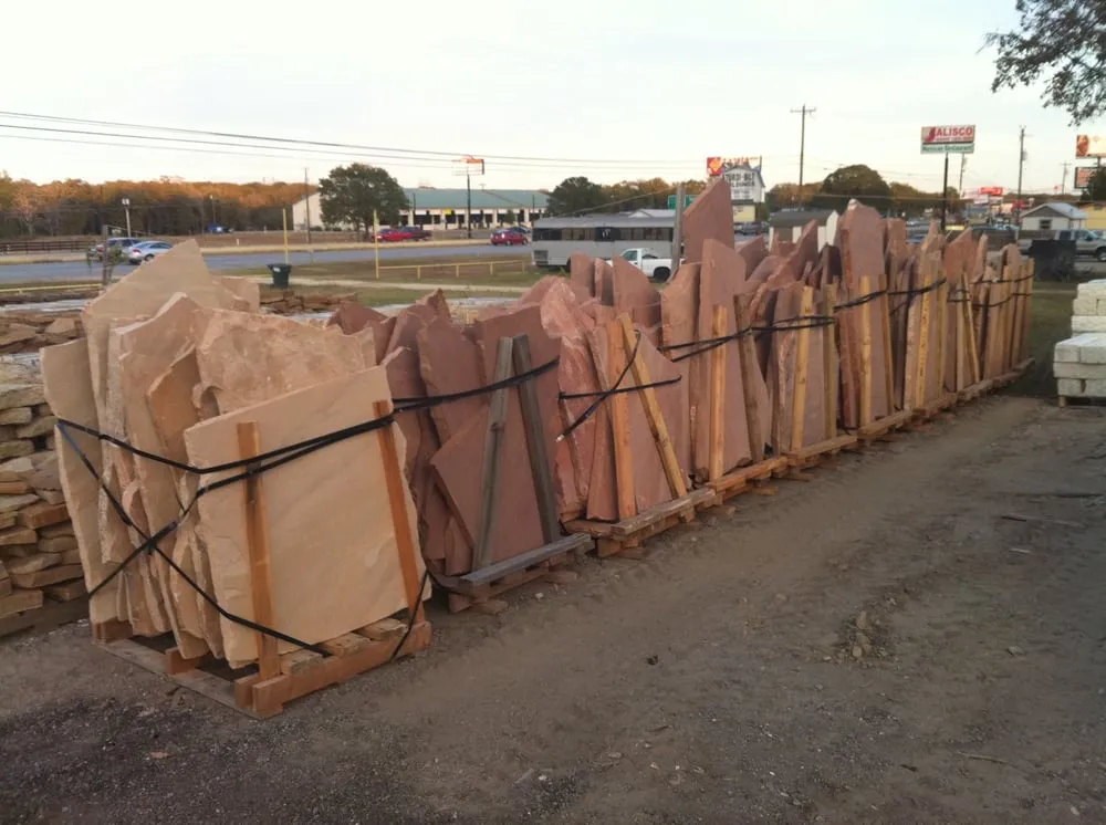 Professional lawn mowing service for year-round maintenance in Bastrop, TX by Bastrop Stone and materials supply