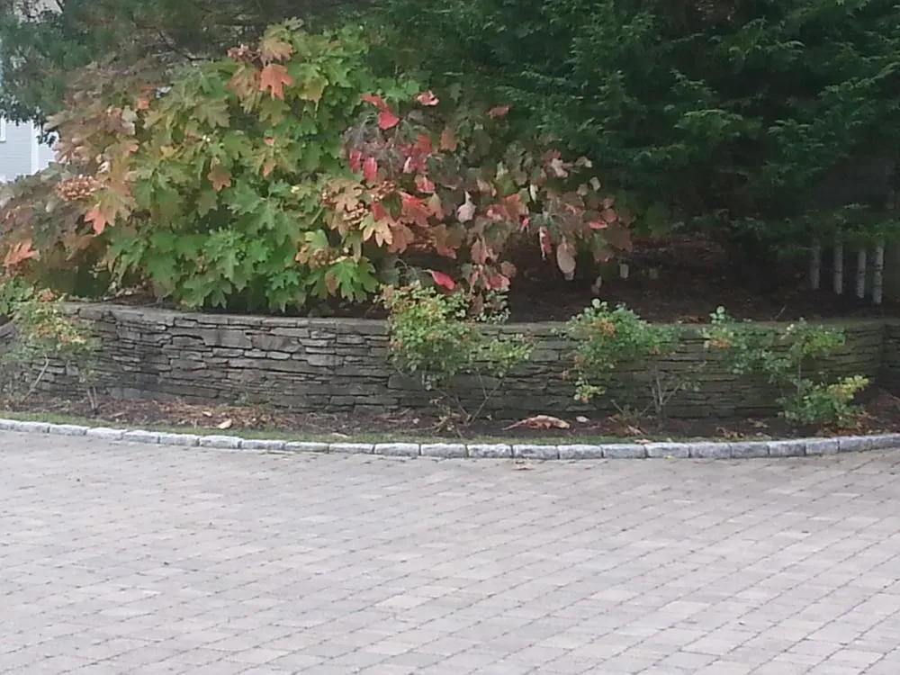 Professional yard maintenance for year-round maintenance in East Falmouth, MA by Creative Masonry and Landscape