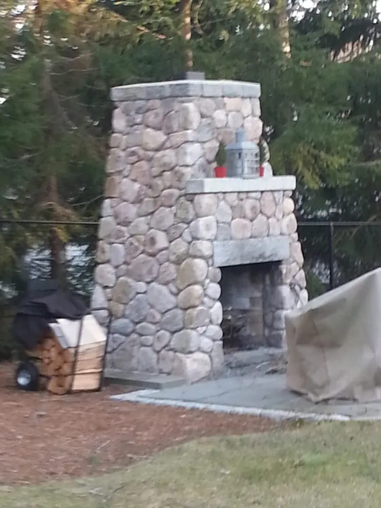 Professional yard cleanup service for residential properties in East Falmouth, MA by Creative Masonry and Landscape