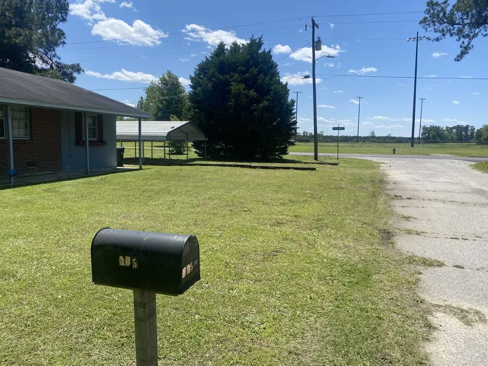Professional lawn mowing service for residential properties in Fayetteville, NC by Crump & Sons