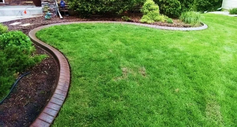 Custom landscape design for year-round maintenance in Buffalo, MN by Curb Creations