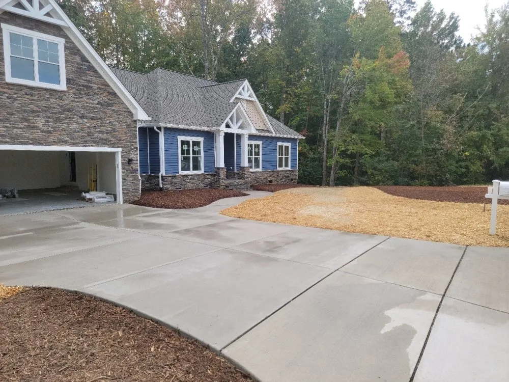 Professional lawn mowing service for residential properties in Trinity, NC by Custom Hardscapes and Grading
