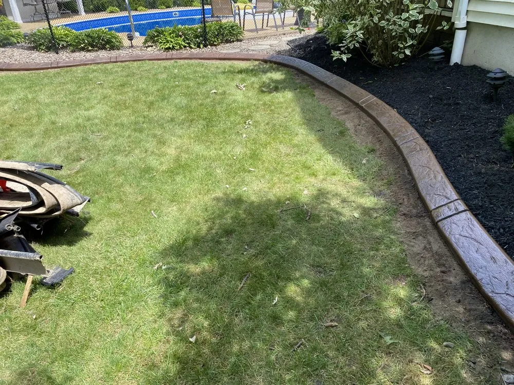 Custom residential landscaping with custom design in Lockport, NY by Dave’s Decorative edging & Landscaping