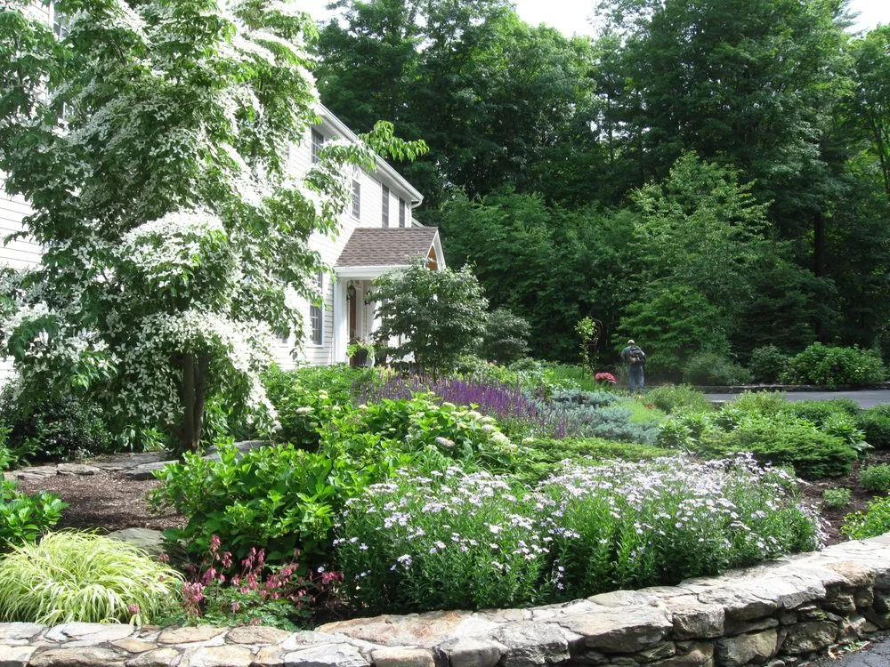 Custom landscape design for year-round maintenance in New Milford, CT by Designing Eden
