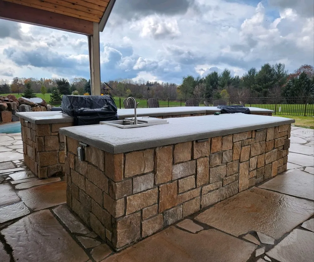 Custom outdoor landscaping with custom design in Knapp, WI by Dreamscapes Natural Pools