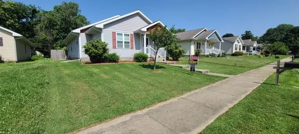 Extra Yard Lawn and Landscape Logo