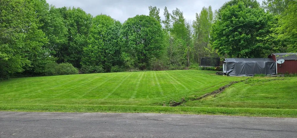 Expert landscaping services for residential properties in Oswego, NY by Feather Cuts Lawn Service