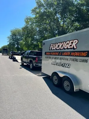 Fluckiger Snow Plowing and Lawn Mowing Logo