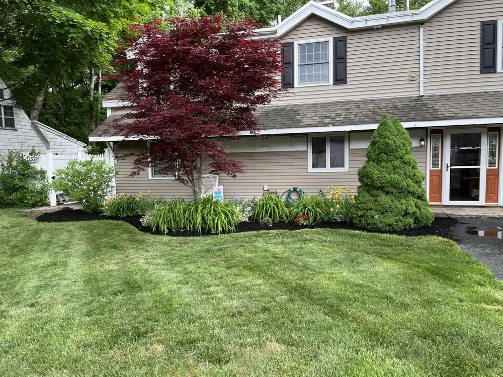 Professional lawn mowing service for residential properties in Charlton, MA by Funk Landscape & Design