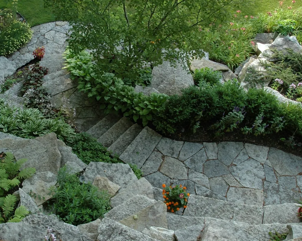 Custom landscape installation with custom design in Allenton, WI by Gamroth Landscaping & Grading