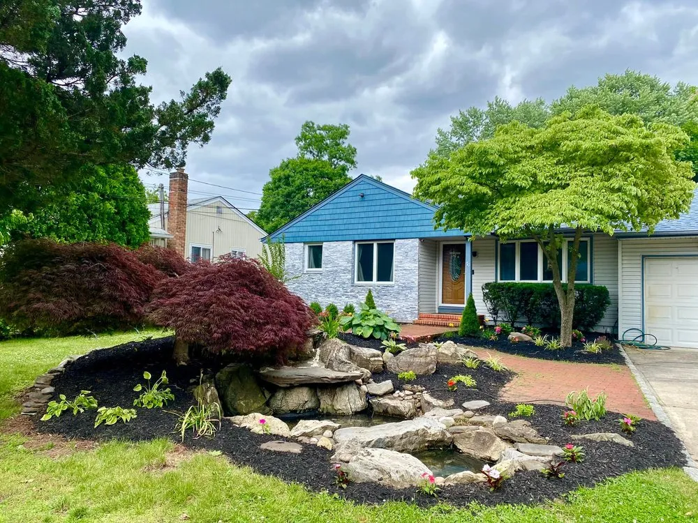 Affordable lawn mowing service for residential properties in Huntington, NY by Garcia Design Group