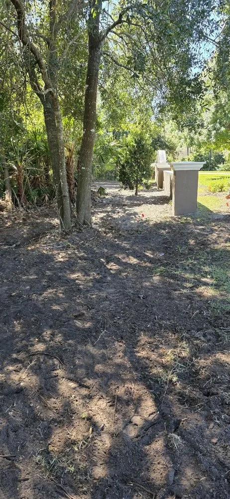 Custom landscape design with custom design in Bunnell, FL by Grindstone Tree Service and Land Worx