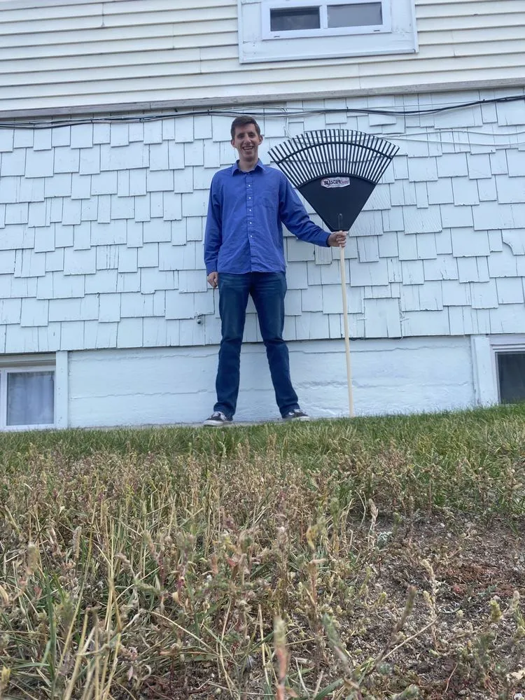 Reliable outdoor landscaping experts serving Cheyenne, WY - Guy With Rake