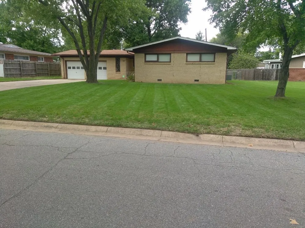 Local landscape installation with custom design in Wichita, KS by Guys With Green Shoes