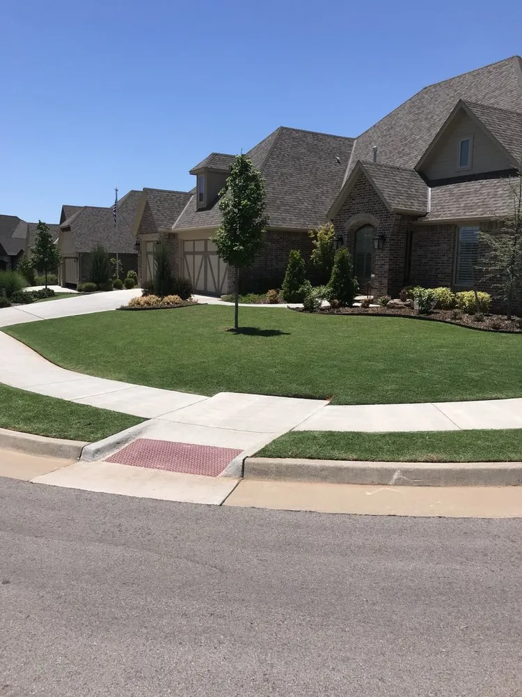 Professional landscape installation with custom design in Chickasha, OK by Heisman Lawncare