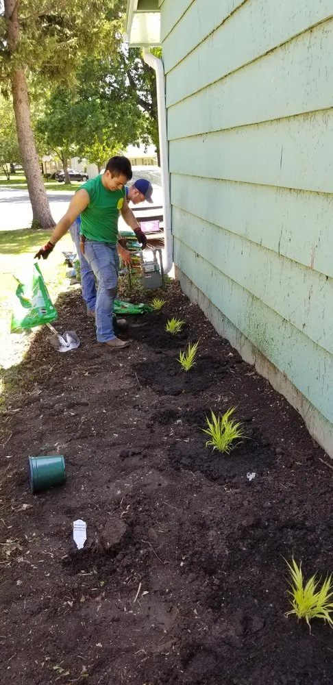 Custom landscape installation for residential properties in Olathe, KS by Help From A Friend