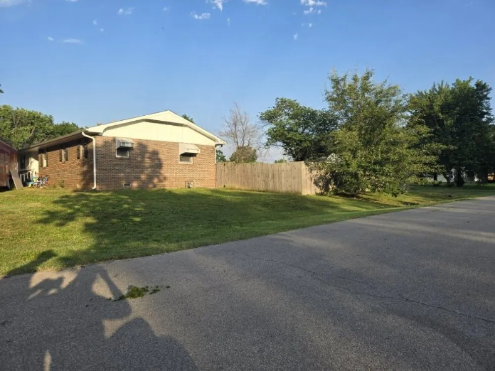 Affordable yard maintenance in Caney, KS by In Dew Time