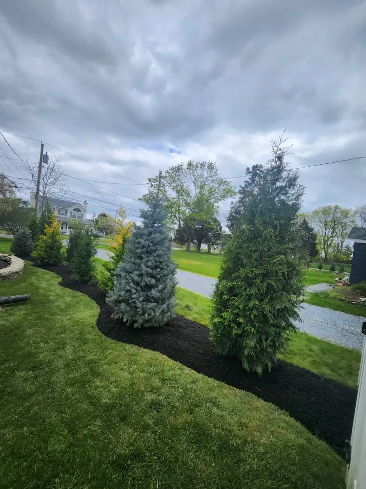 Custom yard maintenance for residential properties in Center Moriches, NY by Juarez Landscaping