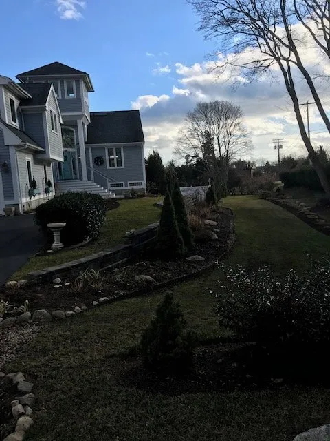 Custom outdoor landscaping for year-round maintenance in Acushnet, MA by Lawn & Order Land Design