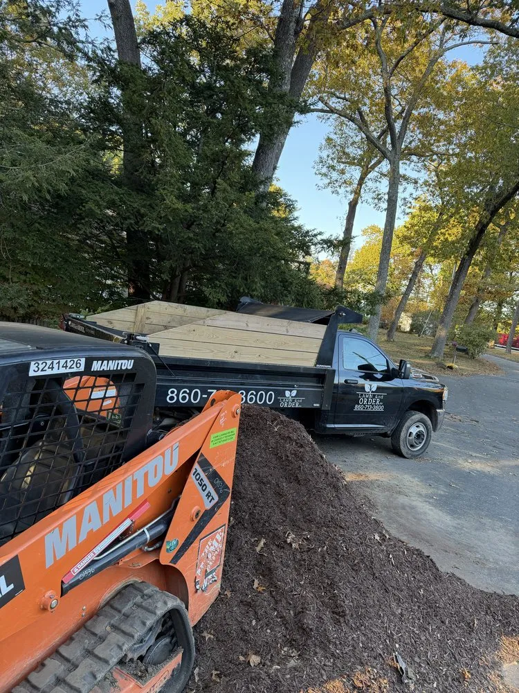 Custom landscape installation with custom design in New Britain, CT by Lawn &nd Order