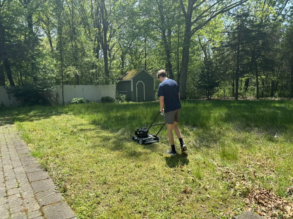 Professional outdoor landscaping in Seekonk, MA - Man Mowing