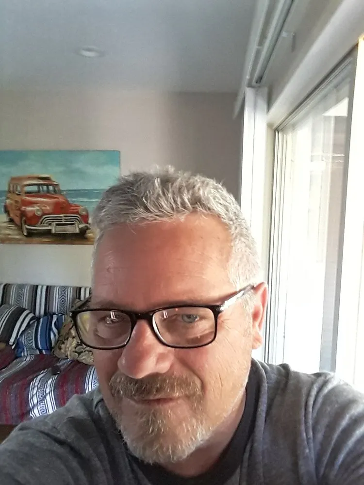 Expert lawn mowing service for outdoor upgrades across Sebastian, FL - Man With Rake