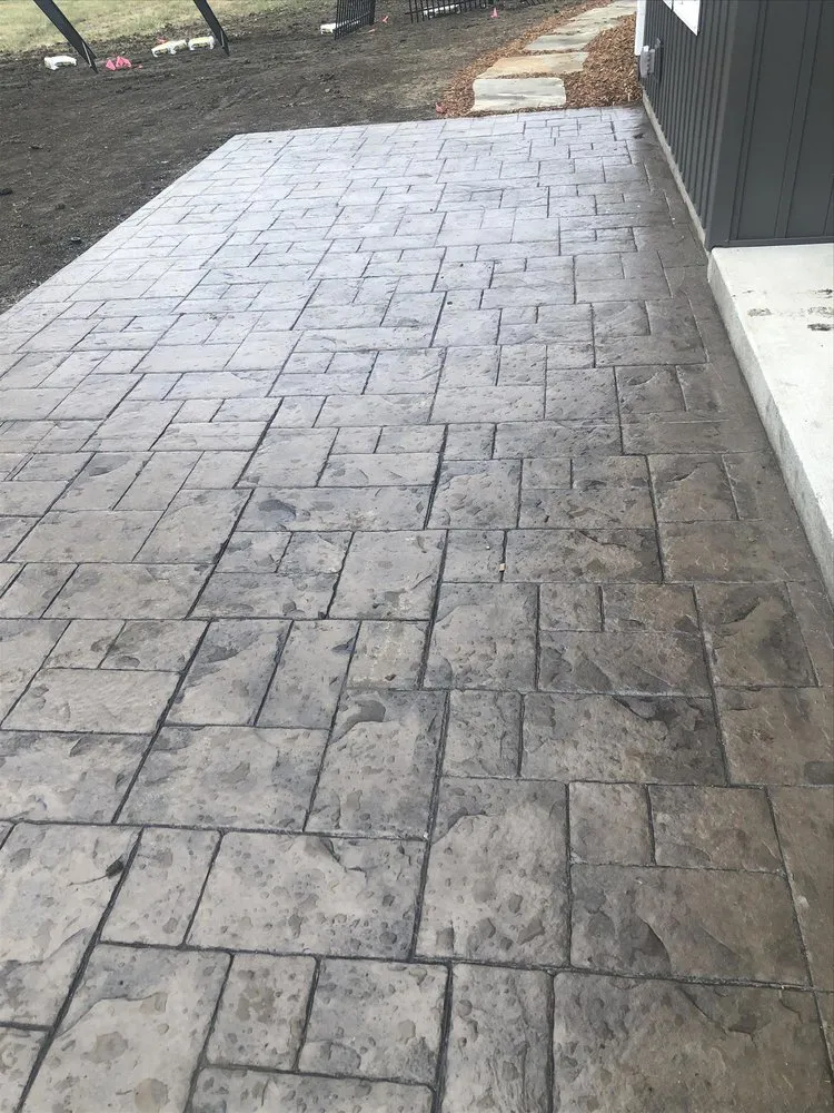 Custom landscape installation for residential properties in Bloomington, IL by Mayo Concrete Construction