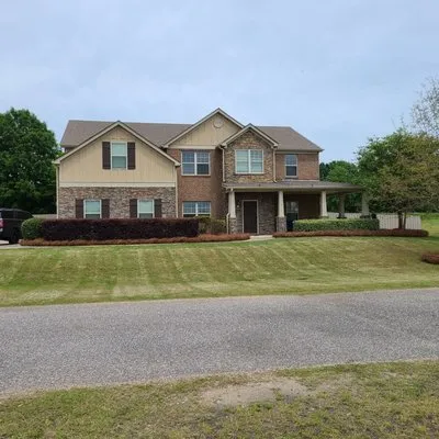 Mel's Lawn Care Logo