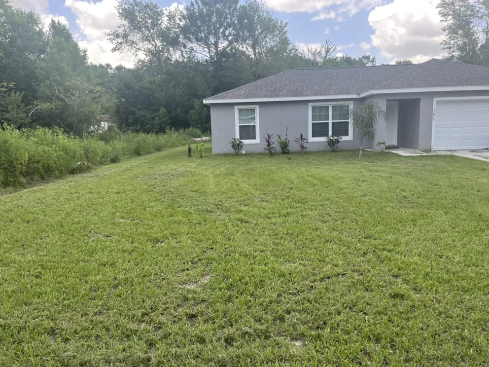 Custom residential landscaping in Summerfield, FL by Moore And Moore Lawn Care