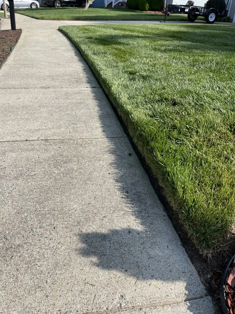 Professional outdoor landscaping with custom design in Newport News, VA by Muscle & Mowers Lawn Care