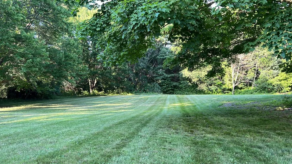 Professional lawn mowing service for residential properties in Taunton, MA by Nunes Landscaping & Construction