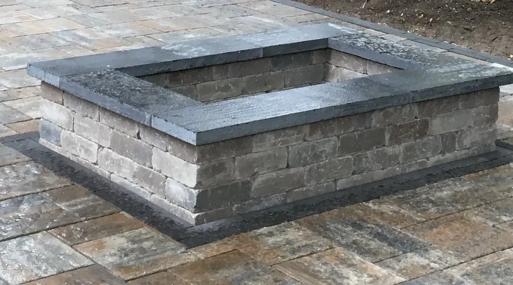 Professional yard cleanup service for outdoor upgrades in East Grand Rapids, MI by Omega Brick & Landscaping