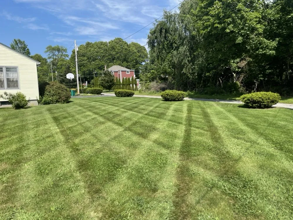 Custom lawn mowing service for residential properties in Saunderstown, RI by Outshine Landscaping