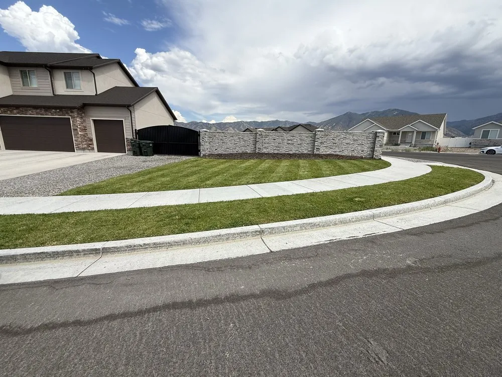 Custom landscape installation for year-round maintenance in Stansbury Park, UT by Pando Lawncare
