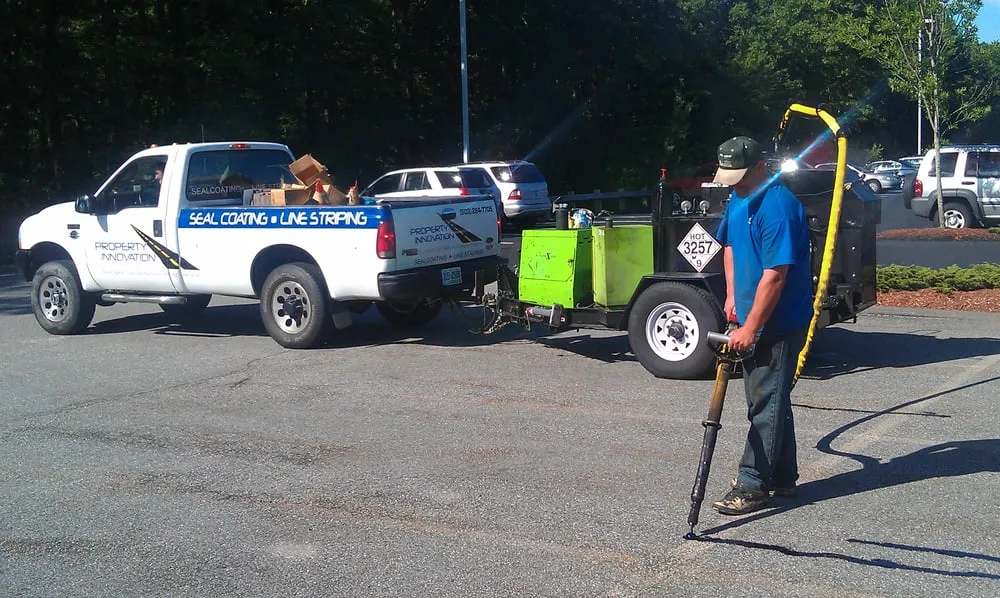 Professional lawn mowing service for outdoor upgrades across Londonderry, NH - Property Innovation Sealcoating & Line Striping