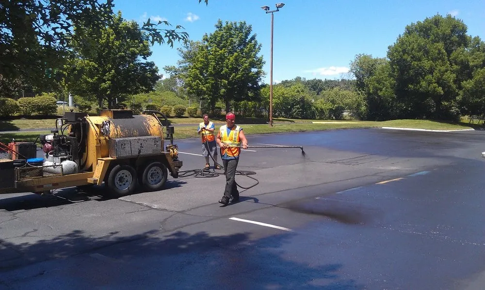 Local yard cleanup service for year-round maintenance in Londonderry, NH by Property Innovation Sealcoating & Line Striping