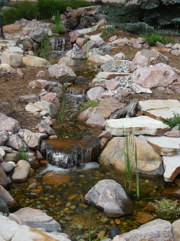 Custom outdoor landscaping for year-round maintenance in Colorado Springs, CO by Purely Ponds & Waterfalls