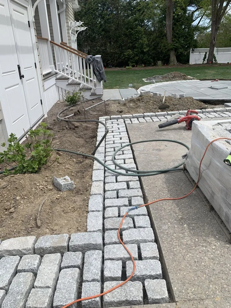 Custom landscape installation for residential properties in Holliston, MA by Rainforest Landscape