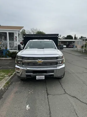 Santos Landscaping and Hauling Logo