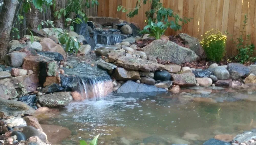 Professional lawn care service for residential properties in Colorado Springs, CO by Serenity Falls Water Features