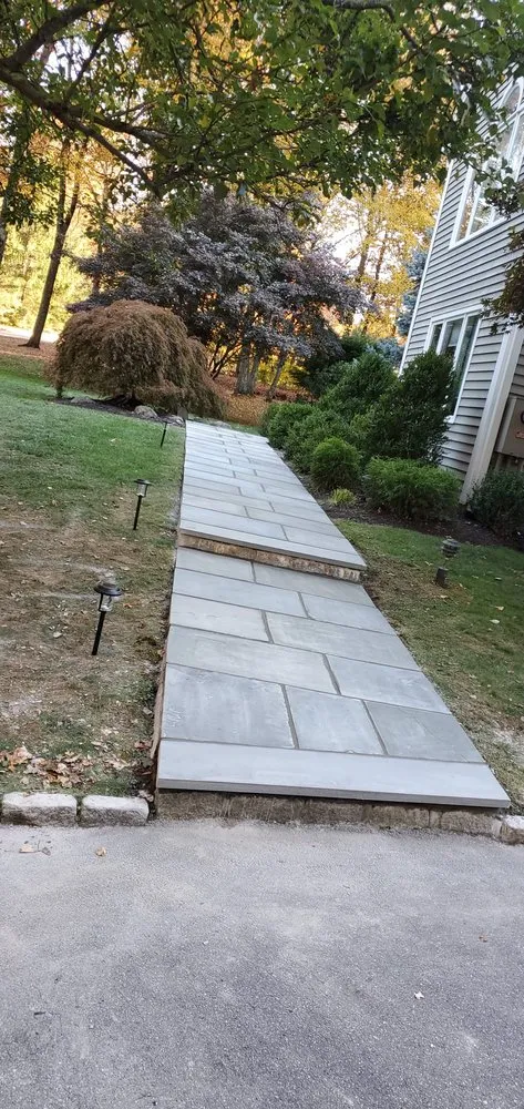 Professional lawn mowing service with custom design across Carmel Hamlet, NY - Stone Walls Construction