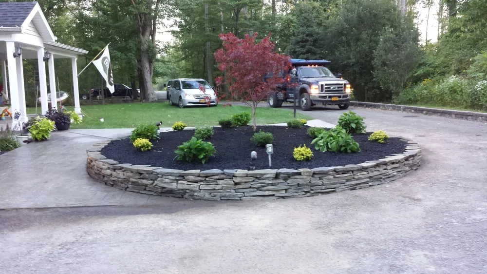 Trusted lawn mowing service with custom design in Amherst, NY by Stonish's Lawn Care & Snowplowing