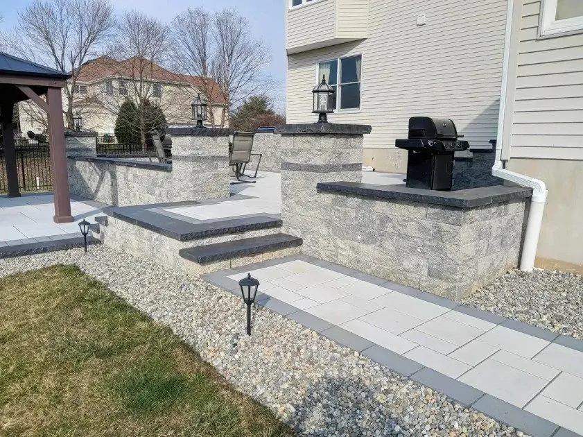 Custom landscape design for year-round maintenance in New Brunswick, NJ by Strong Arm Hardscape