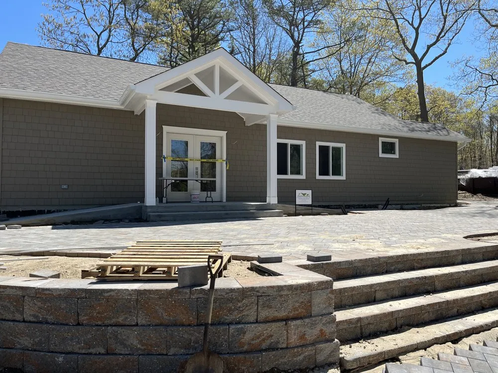 Custom lawn mowing service for residential properties across Center Moriches, NY - Symbiotic Property And Landscape Management