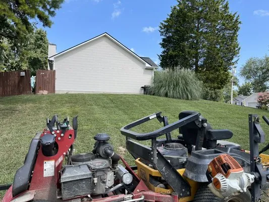 The Grass Barber Lawn Service Logo