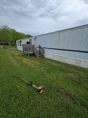 Troyer's Mowing Logo