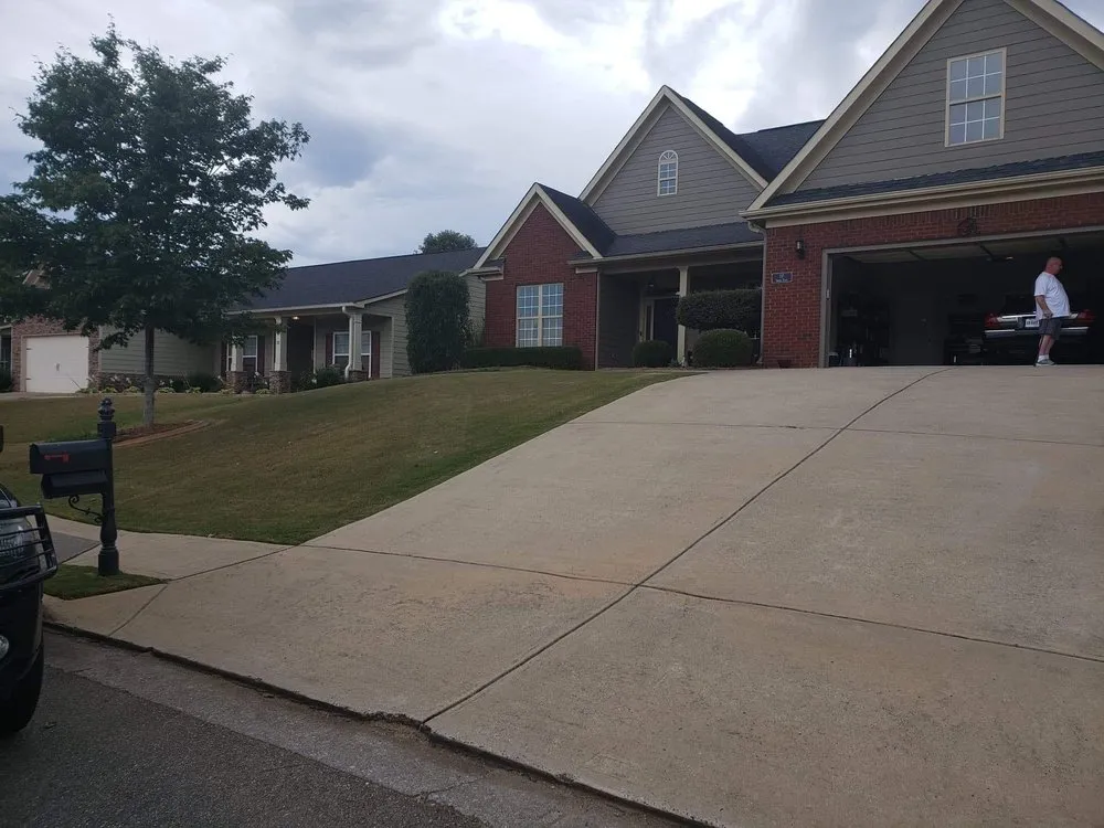 Trusted lawn mowing service for homes across Adairsville, GA - Two men and a mower