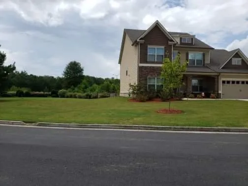 Local landscape design for outdoor upgrades across Adairsville, GA - Two men and a mower
