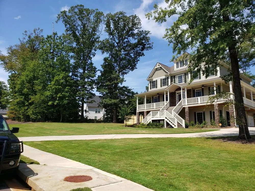 Trusted lawn care service for outdoor upgrades across Adairsville, GA - Two men and a mower